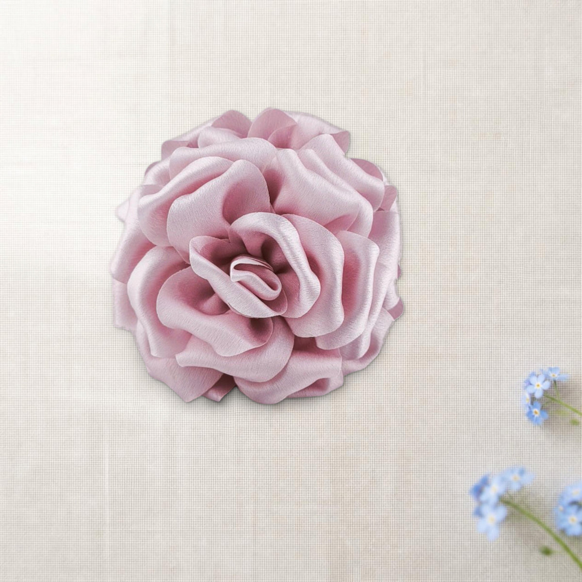 Mola Peónia rosa champanhe em cenário de linho creme com miosótis.