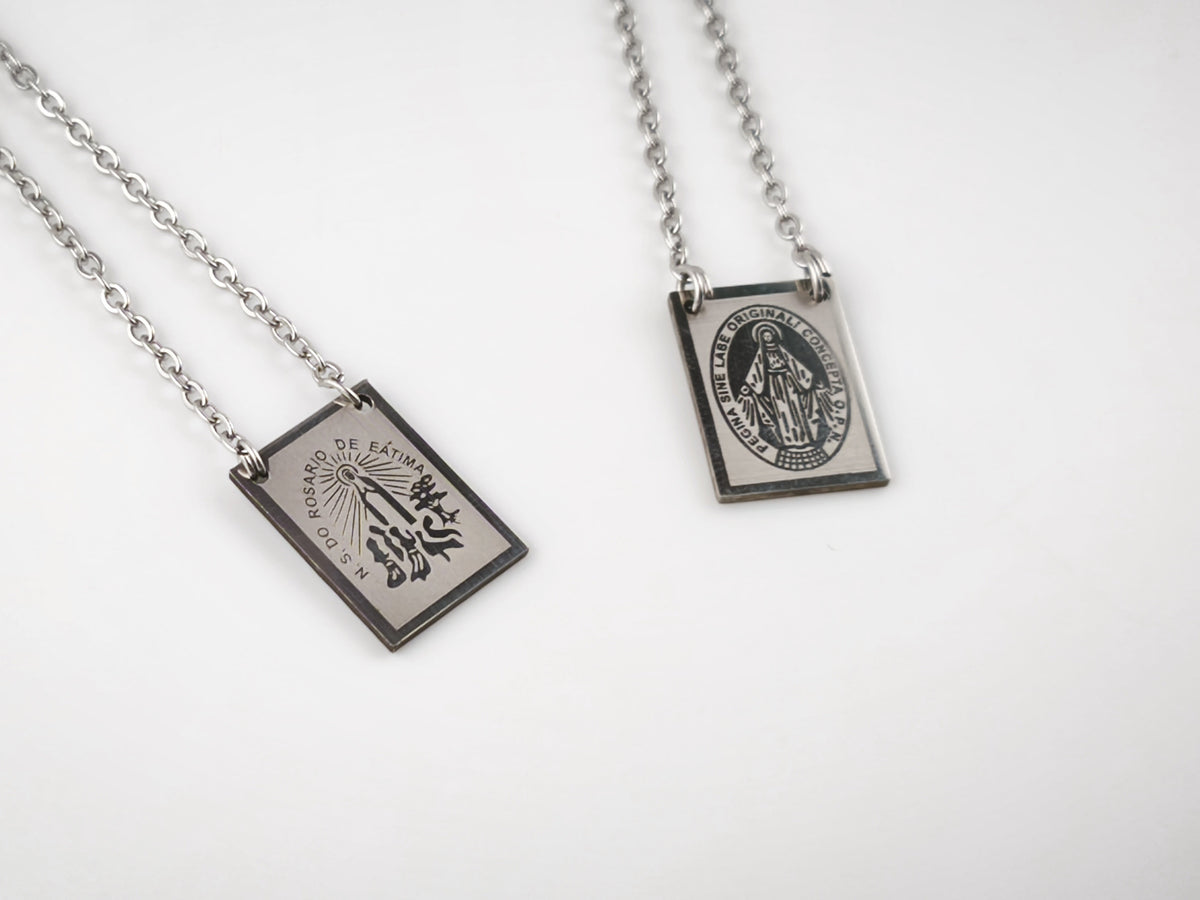 Colar Escapulário Candeia prateado, pormenor das medalhas de Nossa Senhora de Fátima e de Nossa Senhora das Graças.