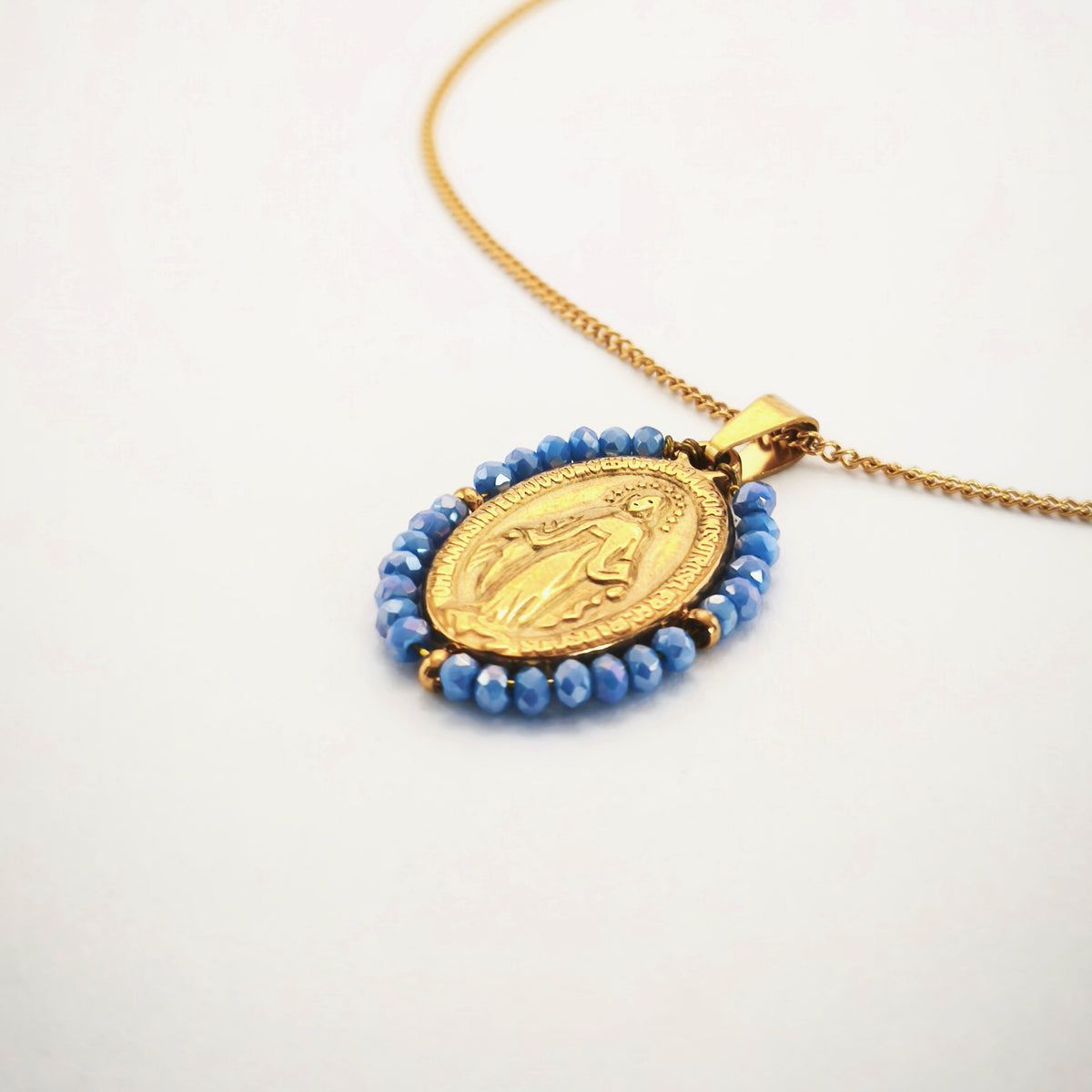 Fio Auréola dourado, pormenor da frente da medalha de Nossa Senhora das Graças rodeada de contas azul céu.