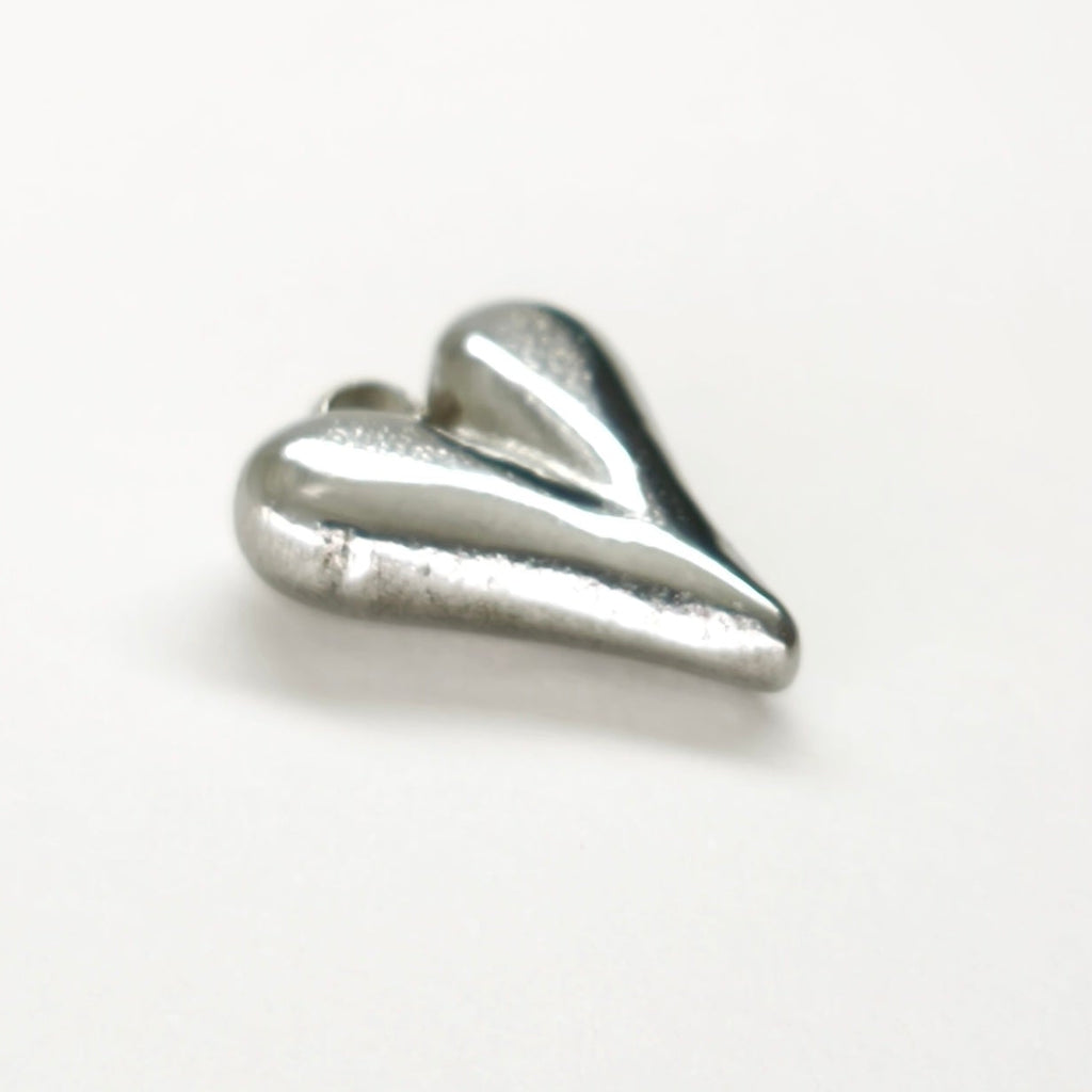 Pendente Essência do Amor prateado em aço inoxidável, em forma de coração.