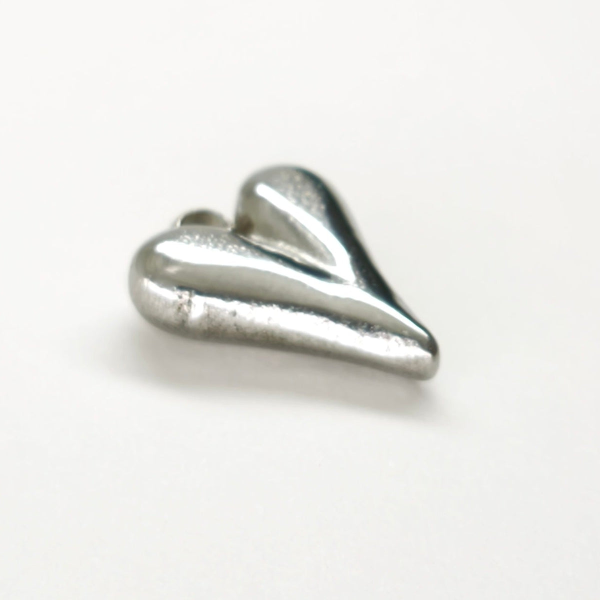 Pendente Essência do Amor prateado em aço inoxidável, em forma de coração.