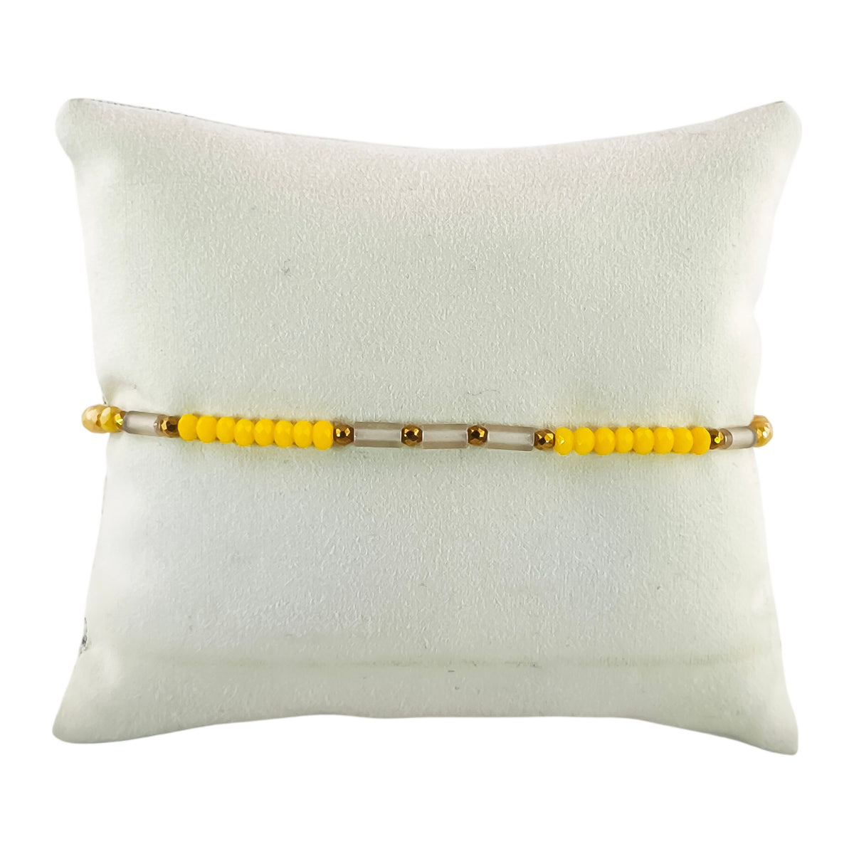 Pulseira Cintilante Lume em amarelo-mel · marfim · cinza quente, apresentada em expositor
