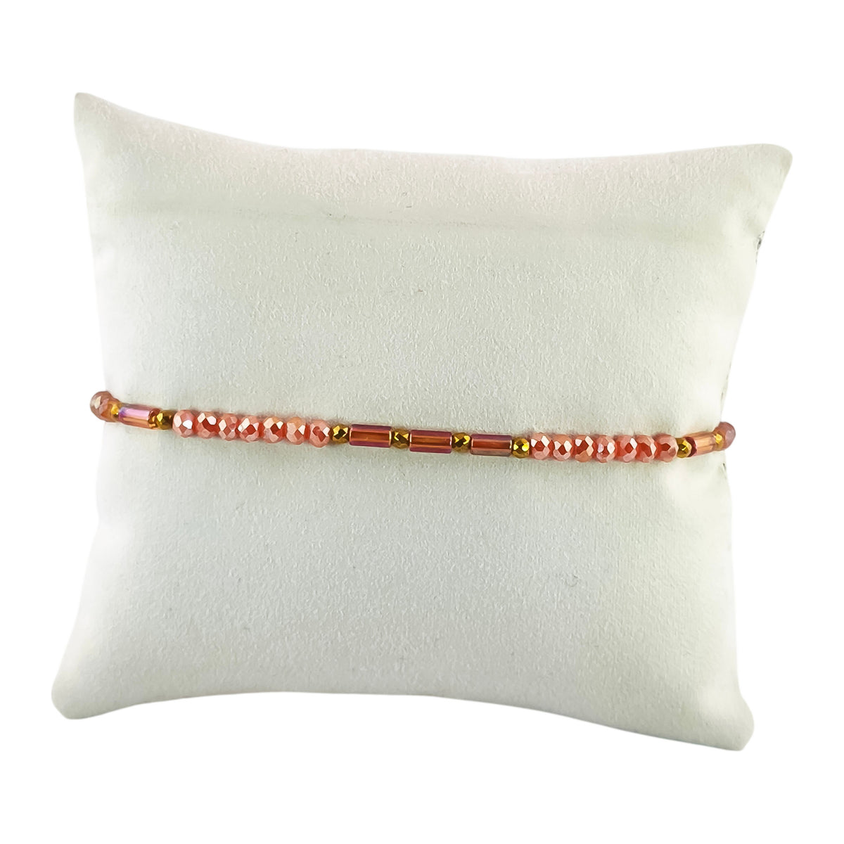 Pulseira Cintilante Poente em pêssego · terracota · cobre rosado, apresentada em expositor
